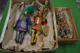 A pair of unusual puppets and a collection of Chinese figures.