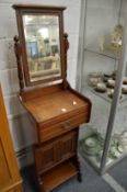 A late Victorian walnut wash stand with mirror.