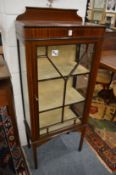An Edwardian inlaid mahogany display cabinet.