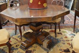 A modern solid hardwood octagonal shaped pedestal centre table.