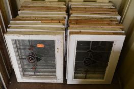 Twenty various small framed leaded lights with stained glass decoration.