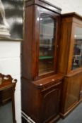 A Victorian mahogany narrow cupboard bookcase.