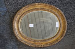 Decorative gilt framed oval wall mirror.