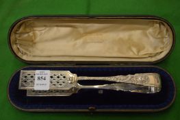 A cased set of silver asparagus tongs.