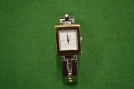 A Ladies Guess stainless steel wristwatch.