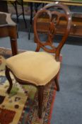 A set of four walnut framed dining chairs on cabriole legs.