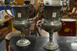 A pair of pewter loving cups.