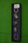 Five decorative brooches.