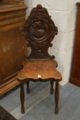 A carved oak hall chair.