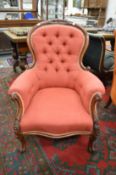 A good Victorian mahogany framed button upholstered armchair.
