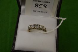 An 18ct gold and diamond five stone ring, size L½.