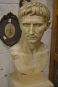 A large Roman style plaster bust of a man.