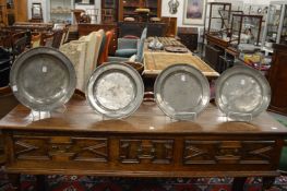 A 19th century pewter circular dish, pair of large plates and a similar plate.