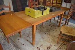 An oak rectangular dining table with pair of extra leaves.