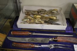 A cased carving set and small quantity of flatware.