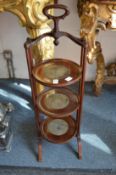A mahogany three tier cake stand.