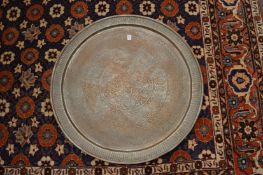 A large Eastern engraved brass circular tray.
