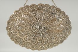 A 19TH CENTURY OTTOMAN EMBOSSED SILVER MIRROR, with relief floral decoration and hanging chain, 30.