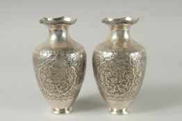 A PAIR OF EARLY 20TH CENTURY SIGNED PERSIAN SILVER VASES, with fine embossed and engraved decoration