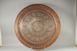 A VERY LARGE QAJAR SILVER INLAID COPPER TRAY, decorated with central roundel depicting two