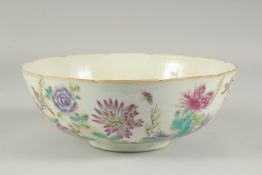A CHINESE FAMILLE ROSE PORCELAIN BOWL, painted with flora, 22.5cm diameter.