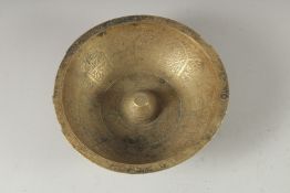 A 19TH-20TH CENTURY PERSIAN QAJAR ENGRAVED BRASS MAGIC BOWL, with panels of calligraphy, 16cm