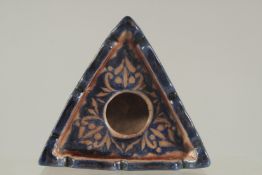 AN ISLAMIC GLAZED POTTERY INKWELL.