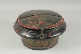 A BLACK AND RED LACQUERED CIRCULAR BOX, with two-panel cover and mounted latch, 33cm diameter.
