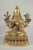 A TIBETAN BRASS BUDDHA, 29cm high.