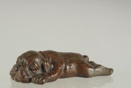 A JAPANESE BRONZE OKIMONO OF A SLEEPING DOG.