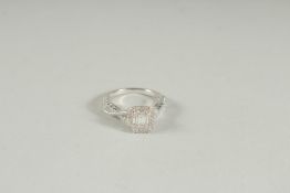 AN 18CT WHITE GOLD AND DIAMOND RING with crossover style band.