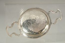 A GOOD GEORGE III SILVER LEMON STRAINER with handles. London 1755. Maker: I. S.