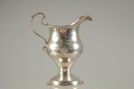 A GEORGE III SILVER CREAM JUG with gadrooned edges. London 1771. Maker: SAMUEL MASSEY/MENTON.