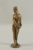 A GOOD HEAVY CAST BRONZE GRAND TOUR STANDING NUDE on a circular base. 10ins high.
