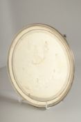 A GEORGE III SILVER CIRCULAR SALVER. 8ins diameter with reeded edge, on three curving feet.London