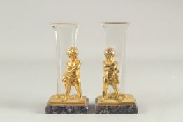 A PAIR OF BLUE JOHN GILT BRONZE AND CUT GLASS FIGURAL VASES. 9ins high.