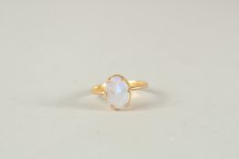 A GOLD AND OPAL RING.