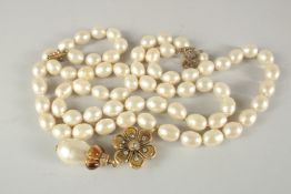 A GOOD LONG CHANEL PEARL NECKLACE, 42ins long with large pearl and enamel drop, in a box.