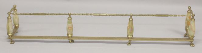 A BRASS AND ONYX FENDER 5ft 6ins long.