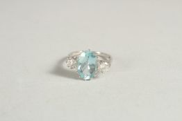 A LARGE OVAL AQUAMARINE AND TWO STONE DIAMOND RING in white gold.