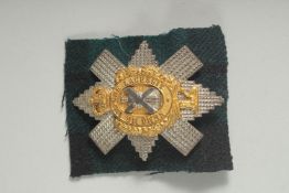 A SILVER AND GILT BLACK WATCH BADGE 'Nemo Me Impure Lacessit'.