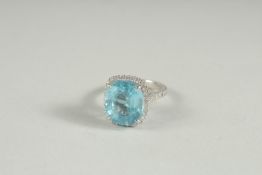 AN 18CT GOLD BLUE TOPAZ AND DIAMOND RING.
