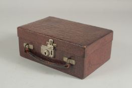 A CROCODILE SKIN JEWELLERY BOX. 7ins long.