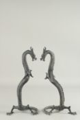 A PAIR OF STANDING PATINATED BRASS MODELS OF CHINESE DRAGONS. 1ft 3.5ins high.