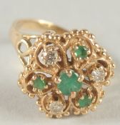 A 14CT GOLD DIAMOND AND EMERALD CLUSTER RING.