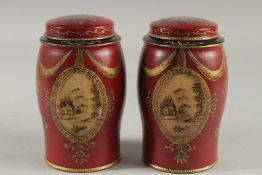 A SMALL PAIR OF RED TOLEWARE TINS AND COVERS. 7ins high.