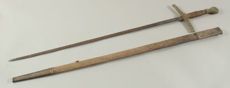 A GERMAN SWORD in a leather scabbard with brass handle. 34ins long.