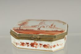 A CONTINENTAL PORCELAIN BOX, the lid painted with a church. 3.25ins x2.5ins.