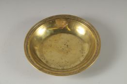 A CIRCULAR BRASS ALMS DISH 