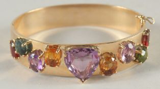 A SUPERB 18CT GOLD BANGLE set with precious stones.
